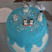 Double Layer With Fondant Snowmen And Penguins This is a double layer cake with buttercream icing and fondant snowmen and penguins with snowflake sequins