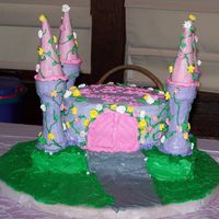 Princess Castle Cake This is a 9 inch round sitting on a 9X13 on a frosted cake board. The turrets are frosted cake and sugar cones. I used a skewer to add...