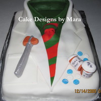 Doctor Coat Christmas Cake This was a yellow cake icing in butterream & covered in fondant with gumpaste accents.