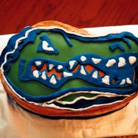 Florida Gators Yellow Cake w/ orange buttercream. All decorations (gator head, etc) in fondant. I used the Wilton oval pans & carved the shape of the...