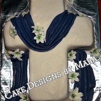 Easter Cake Yellow cake covered in fondant & dusted w/ gold dust. Swag also faondant & dusted. The lilies are royal icing.