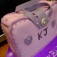 Kylies Cake This is a caramel mud cake with white chocolate ganache filling and coating then covered in fondant. All decorations are fondant also....