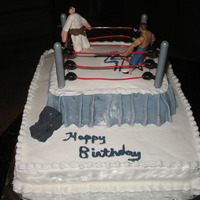 Wrestling Cake Wrestling cake for a friend's son. White cake, strawberry perserves mix with BC filling with BC frosting. My first attempt at fondant...