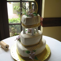First Fondant Wedding Cake WASC with rasberry filling. First gumpast flowers (thanks Edna!), edible gold ribbon, first attempt at draping fondant. I need to improve (...
