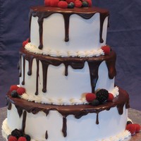 Raspberry Delight White cake with raspberry mousse filling... buttercream with ganache and berries as accents. This cake is based on several similar ones...