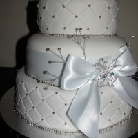 Aimee & Damo's Wedding Cake 6 inch round Mars Bar Mud Cake8 inch round Caramel Mud Cake10 inch round Chocolate Mud CakeCovered in fondant.Quitled. With Satin Ribbon,...