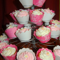 Pink Cuppies Vanilla cupcakes with vanilla buttercream. Gumpaste apple blossoms and daisies.