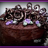 Anniversary Chocolate Style Rich butter 4 layer cake with dark chocolate bc...roses and scrolls made with chocolate candy clay flavored with orange extract and orange...