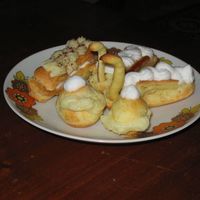 Eclairs Different eclairs filled with vanilla pastry cream and whipped cream.