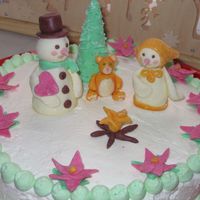 Snowpeople wallnut cake, whipped cream and powder milk fondant figurines. Thanks for looking.:)