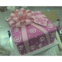Pink Bow Cake Pink buttercream with gumpaste bow and fondant ribbons.