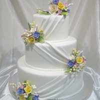 Elegance Display cake for a bridal show. Sizes 6, 9 and 12. Fondant covered with gumpaste flowers.