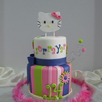 Hello Kitty Fondant covered with fondant decorations. Handmade hello kitty topper. I loved the vibrant colors on this cake!!