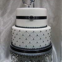 Black And White This was a 2 tier display cake for a bridal show. Fondant covered, sugar pearls and non edible buckle.