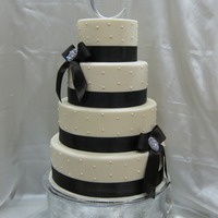 Ivory Wedding Cake This was made for a bridal show. Ivory fondant with brown satin ribbon and bling broaches. Sizes were 6, 8, 10 and 12.