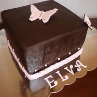 Elva's Birthday Cake I made this cake for a charitly that I belong to. This is a white cake with buttercream frosting covered in chocolate fondant decorated...