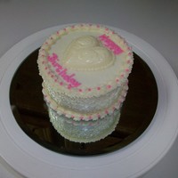 Heart Birthday 4-inch round 2-layer chocolate with chocolate chips cake. Iced in buttercream. Candy is almond bark. Used square embossing soap stamp for...