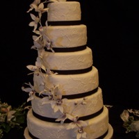 Embroidery Orchid Cake Fondant covered wedding cake with buttercream brushed embroidery and gumpaste orchids.