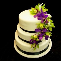Orchid Wedding real flowers were used on this cake. They were some cala lilies, green cymbidium orchids and some other purple orchid. They were all wired...