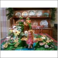 Prince Froggy Went A' Courtin' This is a cake for my 7 year old granddaughter's birthday . She wanted Frogs, Flowers, and Fairies. The tree stump is four 9 inch...