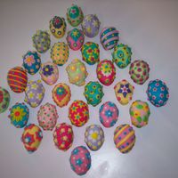 Easter Eggs These were made with the Wilton mini egg pan. Two egg halves put together, covered in very thin fondant, and all fondant decorations. Each...