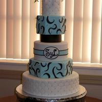 5 Tiered Light Teal & Brown Wedding Cake This is a 4/6/8/10/14 inch, rolled fondant iced cake with a 5 inch foam spacer and live flowers. The 8 and 10 are Hexagon shaped. The cake...