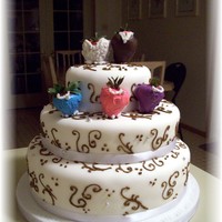 Scrolls Three tier wedding cake, bottom tier white cake, middle tier chocolate cake & top tier white cake. Strawberries of bride & groom,...