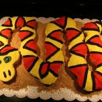 Snake Cupcake Snake cake for an Indiana Jones birthday party. Made of cupcakes. BC icing, graham cracker crumbs for sand. Thanks to all the CC posters...