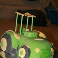 Tractor Cake Ok, im not happy with this tractor at all :( but let me know what you think please...made with MM fondant except for the straws holding up...