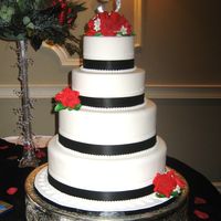 Winter Wedding/black And White For a bride in January. Her colors were black/white/red. Really blended in well with her decor. All fondant, satin ribbon, swarovski topper...