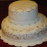 50Th Wedding Anniversary Two tier white almond cake with caramel filling. The cake was topped with a vintage bride and groom but I didn't get a picture of the...