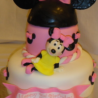 Minnie Mouse This cake is yellow with ganache filling. The head piece of the ears is cake, the ears are gumpaste. Minnie is a RKT with fondant.