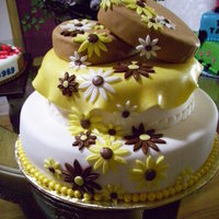 Daisy Wedding Cake Two hearts adorn the top of this two tier wedding cake. Yellow and browns used to have a little something different.