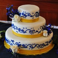 Simple Blue And Gold Wedding Cake blue scroll on white fondant and gold edible ribbon