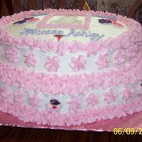 Graduation Cake This cake I used two different sized flower shaped pans. The cake was yellow and it had chocolate pudding in the center. It had buttercream...