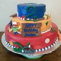Handy Manny Birthday Cake 3 teir, filled in with crusting buttercream and iced with it also. Fondant Accents, Plastic Handy Manny figure.