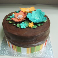 Co-Worker B-Day Cake This cake is chocolate cake, covered with chocolate ganache. All flowers are made out of fondant w/ a hint of glitter.
