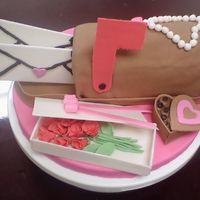 Valentine Gifts Strawberry cake with chocolate chips and chocolate buttercream, covered in fondant with gumpaste decorations.