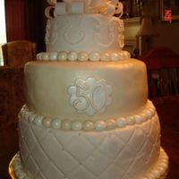 50Th Wedding Anniversary Cake 50th Wedding Anniversary Cake made for neighbor's parents. 6", 10" and 12" rounds with fondant accents.