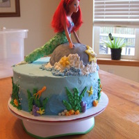 Ariel, The Little Mermaid Chocolate cake with oreo filling, buttercream except for the fish tail and rock are made/covered from findant. My kids wanted to help so...