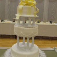 0811290007.jpg This is my first wedding cake I did for my niece, and my first cake for anyone ever. Buttercream frosting with white fondant and...