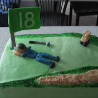Golf Course Cake Vanilla Cake with raspberry filling. The man and the putter are made out of modeling chocolate