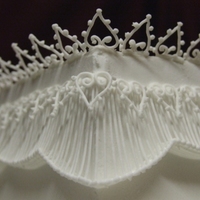 Extension And Lace Work Corner of cake with extension and lacework. First attempt at these - learnt on the PME Royal Icing course