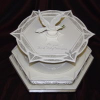 First Holy Communion Cake Royal-iced fruit cake with run out collar and dove. Filligree inserts, stringwork base nd silver filligree.