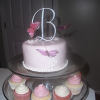 Butterfly Cake & Cupcakes This cake was made for a couple that had a destination wedding, but wanted to celebrate with family once they returned home. The top tier...