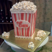 Popcorn Cake - Small This is a strawberry cake, filled with buttercream and iced with fondant. Popcorn made out of mini marshmallows, painted with thinned icing...