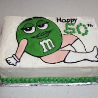 Green M&m Cake This is a yellow cake with almond buttercream. The M&M on the front was done color flow style with royal icing. I used an outline that...