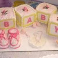 Baby Blocks And Booties Blocks and Booties are cake ....cakes are almond..everything else is mmfondant I hand made the bib rattle and pacifier and little booties...