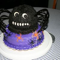 Img_0888.jpg Tiered cake - 2 layer yellow for base layers with chocolate round using sports ball pan for spider. Buttercream icing and licorice legs....