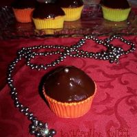 Boston Cream Cupcakes Yellow cupcakes with pastry cream filling, glazed with bittersweat chocolate ganache and topped with a single silver pearl.